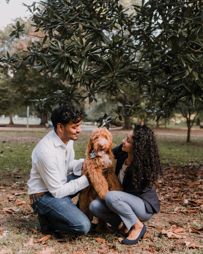 Dr. Paul with family and dog in a park, relaxed and smiling